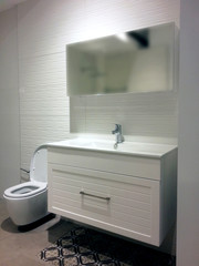 Modern bright bathroom design with a toilet.