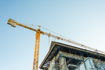 Fototapeta premium Construction crane and buildings.