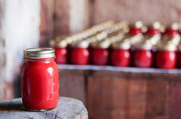 traditional tomato sauce conserved in  glass jar on a wooden base