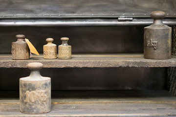 old weights  on work bench - vintage kg weights on wooden background