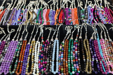 rows of prayer beads for sale in the market
