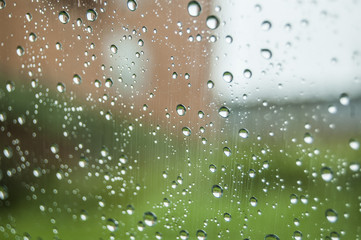 Raining drops water on windows green background