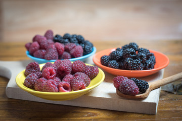 Fresh berries blackberry and raspberry on a plate in vintage style