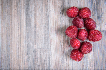 Healthy raspberry fresh organic fruit on a wooden table in vintage style
