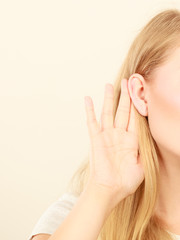 Woman putting hand ear to hear better