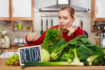 Woman having green diet vegetables, detox sign