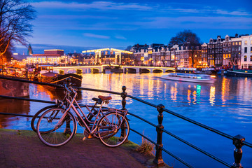 Skinny bridge and Amstel river in Amsterdam Netherlands at Dusk, selective foreground focus on...