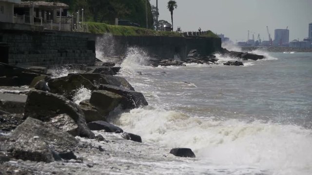Big Waves Crashing on Stone Beach. Slow Motion in 96 fps. Large storm waves crashing on rocky inlet pier. Sea Storm. The waves are rolling on a pebble stone beach. Sea Surf on the beach.