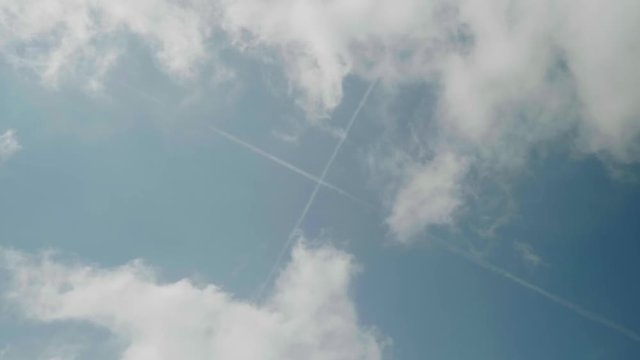 Concept view of sky with crossed traces of planes in clouds