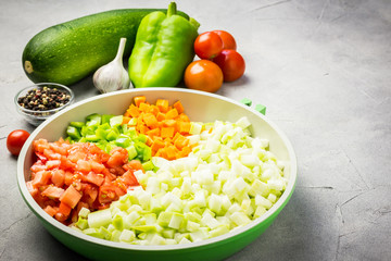 Zucchini, tomato and pepper saute. Selective focus, copy space.