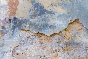 background texture old wall with remnants of varicoloured plasters