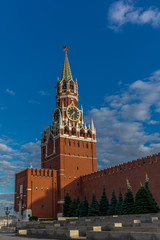 Fototapeta premium Spasskaya clock tower on the Kremlin walls with the moon in the backgroud