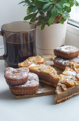 Apple pie with muffins and coffee on window background. Moning breakfast.
