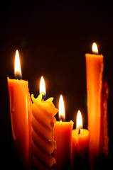 light candle burning brightly in the black background