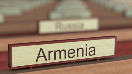 Armenia name sign among different countries plaques at international organization. 3D rendering