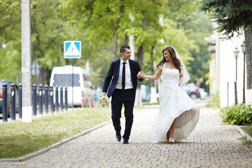 Happy bride and groom on a city street.