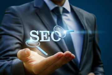 Businessman showing seo on a blue background.