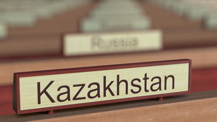 Kazakhstan name sign among different countries plaques at international organization. 3D rendering