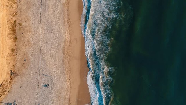 Aerial top shot of sandy golden beach waves and turquoise ocean. Perfect for wordpress website video background or nature travel video
