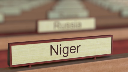Niger name sign among different countries plaques at international organization. 3D rendering