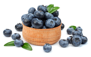 blueberries in wooden bowl isolated on white background