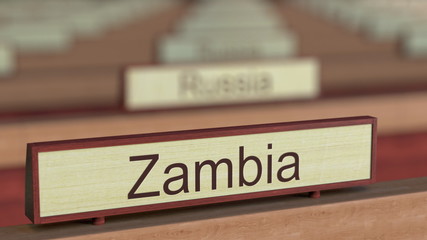 Zambia name sign among different countries plaques at international organization. 3D rendering