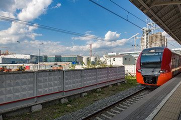 Highspeed passenger train arrives on the platform on a sunny summer day
