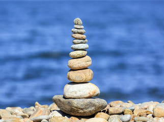 A stone pyramid laid out on the shore of Lake Baikal. Photo toned.