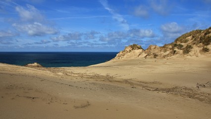 Sand dune and blue sea. Rubjerg Knude, Denmark.
