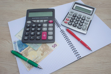 analysis of the annual budget with calculator and money on the table. financial concept