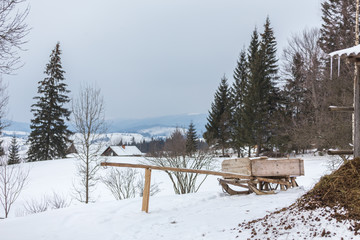 Rural alpine winter landscape with fence and path
