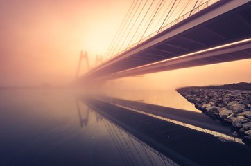 Fototapeta Cable stayed bridge, Krakow, Poland, in the morning fog over Vistula river obraz