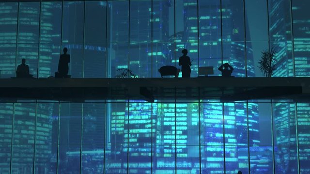Silhouettes In An Office Building Against Of Skyscrapers