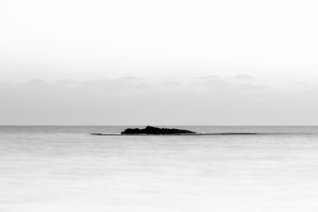 Fototapeta premium Island rock in the mediterrenean sea. Black and white photo