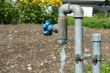water valve pipe with running water in garden hot