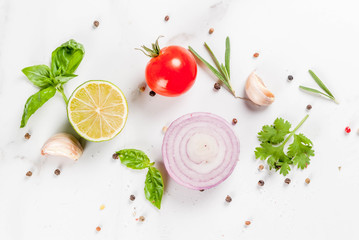 Food cooking background, white marble kitchen table. Spices and herbs for cooking dinner -...