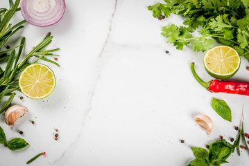 Food cooking background, white marble table. Spices, herbs for dinner - coriander, parsley, basil,...