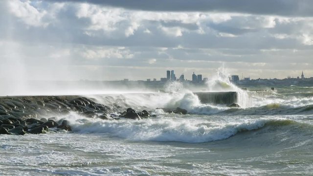 water cascade from waves crashing to the pier