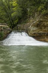 Fototapeta na wymiar Como Falls - A small waterfall on a creek.