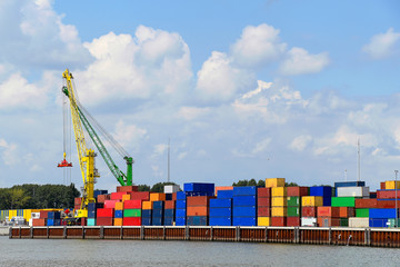 colorful shipping container with crane on commercial dock on the Rhine River
