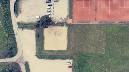 Aerial view of people playing beach volleyball.