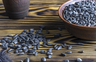 sunflower seeds are in a bowl on a wooden table
