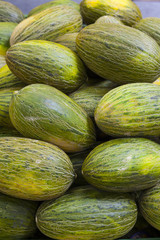 box of santa claus green and yellow melons in the market