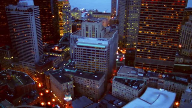 Aerial shot of glittering city at twilight.