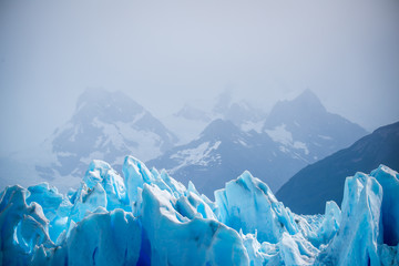 Glacier on the background of snow-capped mountains. Shevelev.