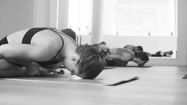 Students performing baddha konasana