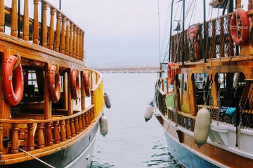 Fototapeta na wymiar Sailing ships for sea excursions in the city harbor (Antalya, Turkey).