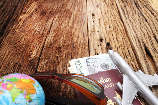 travel concept , Go on an adventure, The world map and the passport and money on a wooden table. Top view.