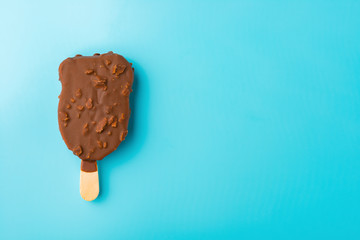chocolate outer ice cream starts melting on a blue background