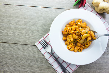 Spoon picking up macaroni,Top view.